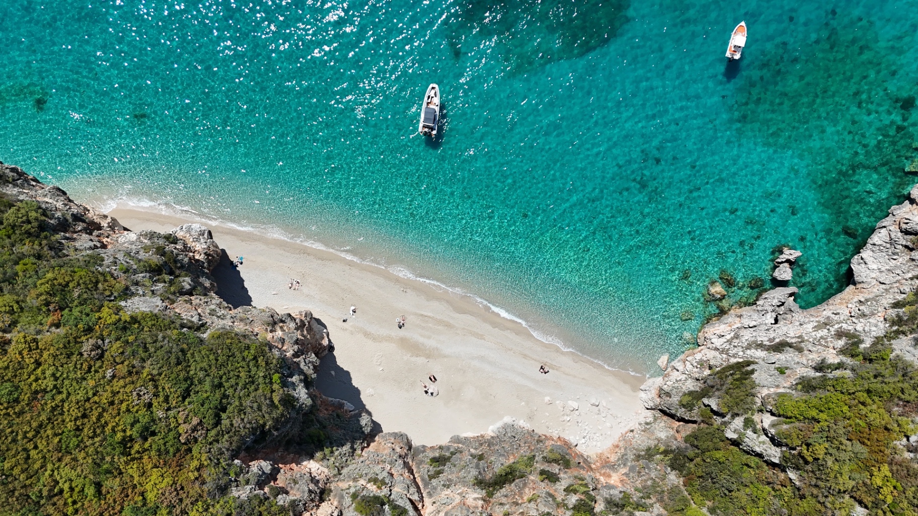 Aerial view of a hidden beach with turquoise water